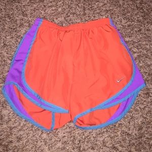 Bright orange, light blue, and purple Nike shorts