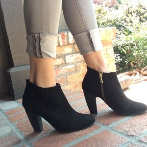 Black booties with gold zip