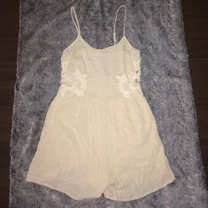 Light pink romper with lace cutout side details