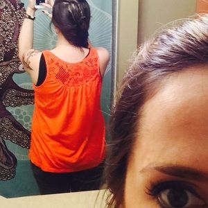 Orange crocheted back pleated front jersey tank