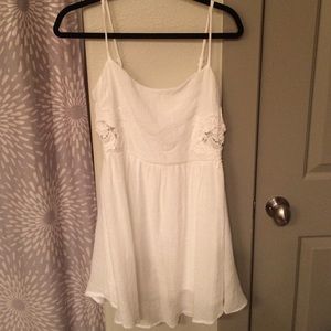 White sundress with side lace cutout details
