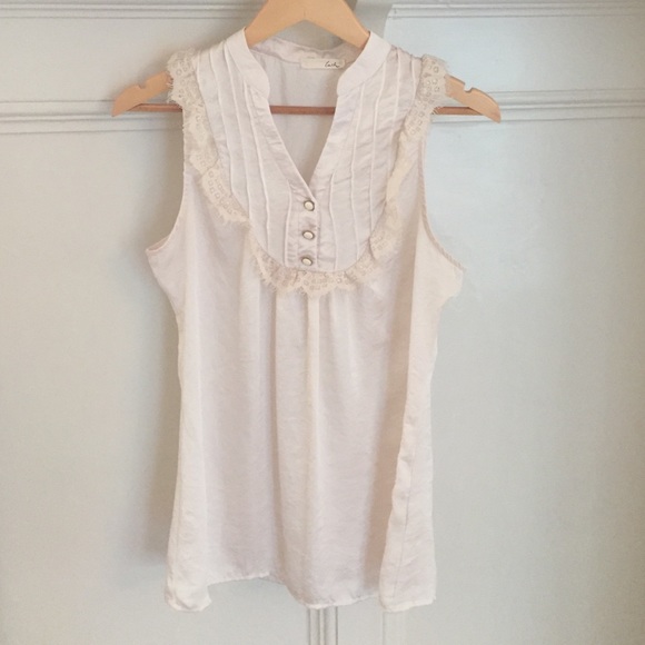 Cream silk blouse with lace detail.