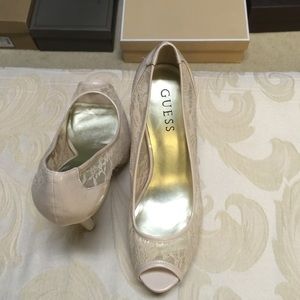 Nude peep toe pumps by Guess