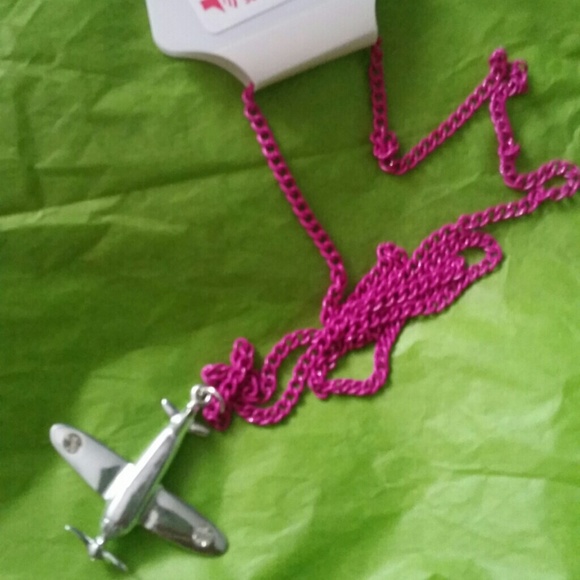 Air plane necklace with hot pink chain.