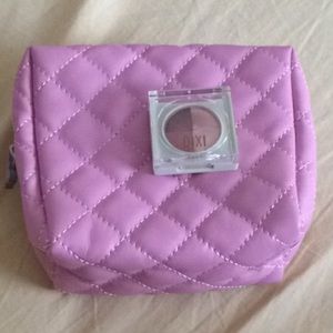 Small pink Pixi makeup bag and nude eyeshadow.