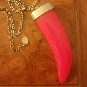 A long chain, bring pink shark tooth