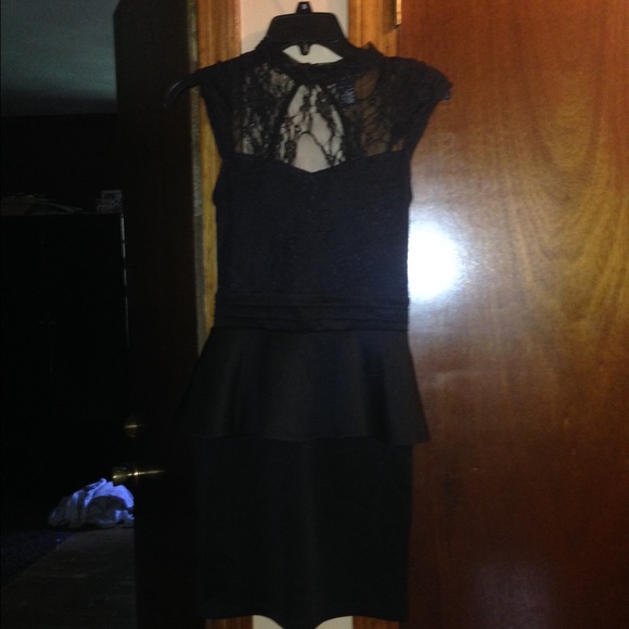 Black peplum dress with lace detail and open back