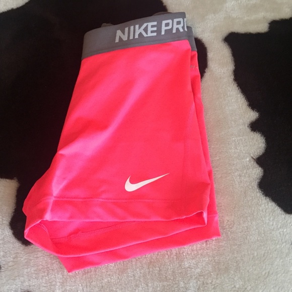 Nike pro shorts being held