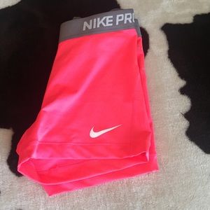 Nike pro shorts being held