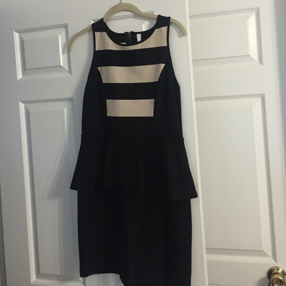 Form fitting cream and black ruffled waist dress