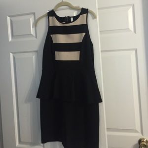 Form fitting cream and black ruffled waist dress