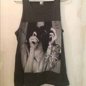 naked tattooed woman with camera tank