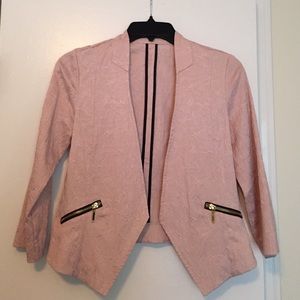 Pink blazer with black and gold zippers
