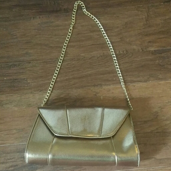 Gold Metallica clutch with chain strap .