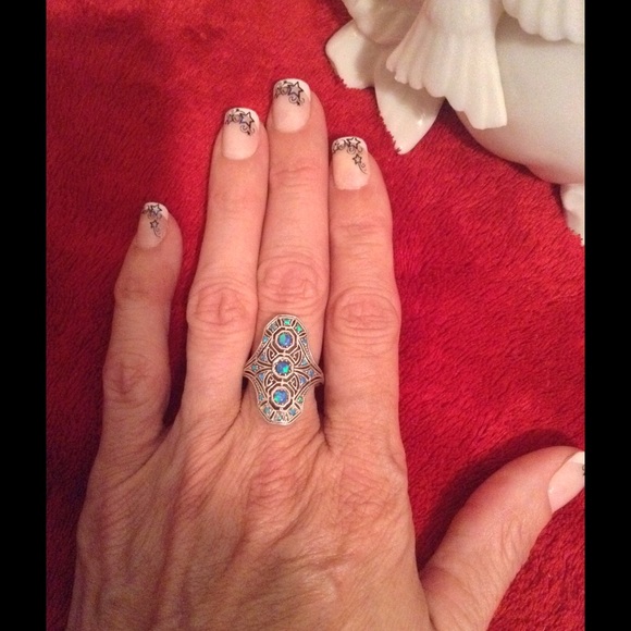 A blue topaz and blue fire opal SS ring in size 6