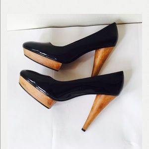 Black leather heels with wooden platform .