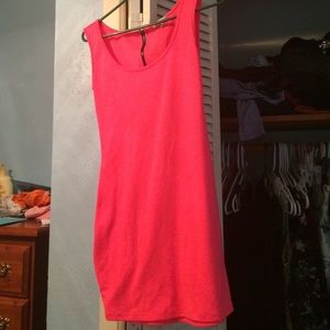 A hot pink dress with a black zipper in the back.