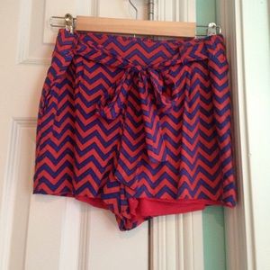 NAVY AND ORANGE CHEVRON SHORTS from Francesca's