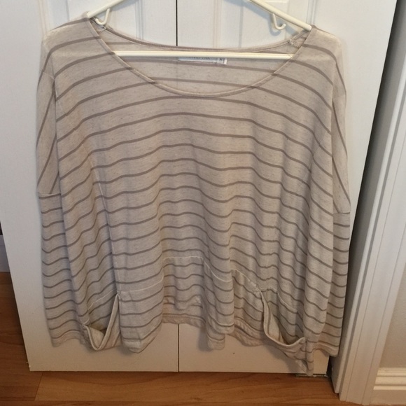 Mink pink top with two side pockets.