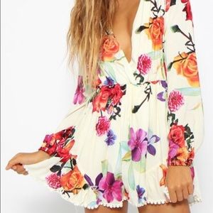 Cream colored romper with flowers.