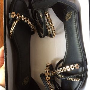 Black gladiator sandals with gold chain