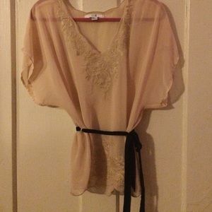 Cream colored sheer flutter top with black belt