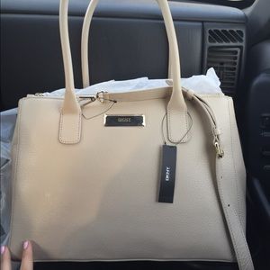 Tan DKNY handbag.