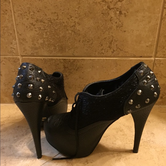 Booties with fur and spike detail.