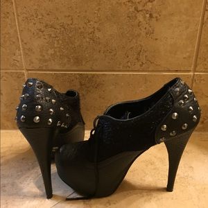 Booties with fur and spike detail.