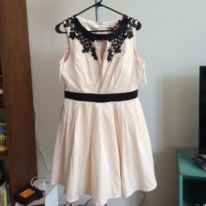 Cream colored dress with black accents