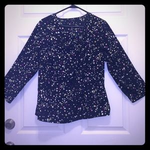 Dressy top with unique polka dot print.