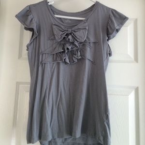 a ruffled, short sleeved top
