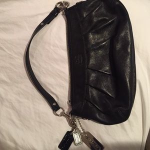 Black leather coach purse with purple lining