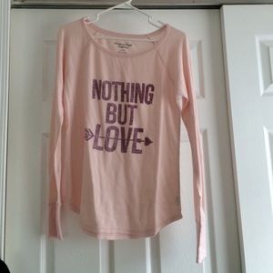 A pink, see through, long sleeved shirt