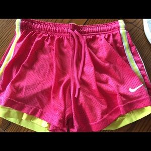 Pink Nike Dri-fit shorts with yellow lining