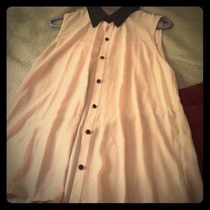 Nude sleeveless button-up shirt with black collar