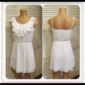 Sleeveless white ruffle dress.
