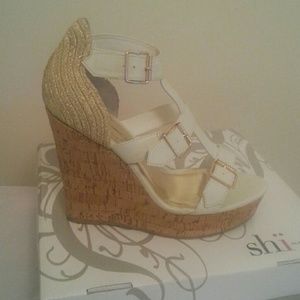 White wedged heels with gold buckles