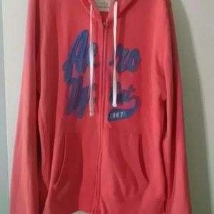 Salmon colored full zip-up sweater