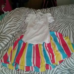 A white lacy shirt with a colorful longer skirt