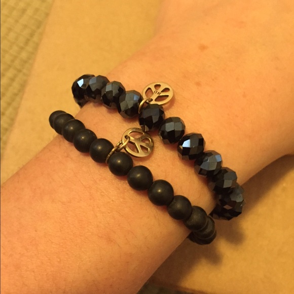 Black beaded bracelet with gold peace sign