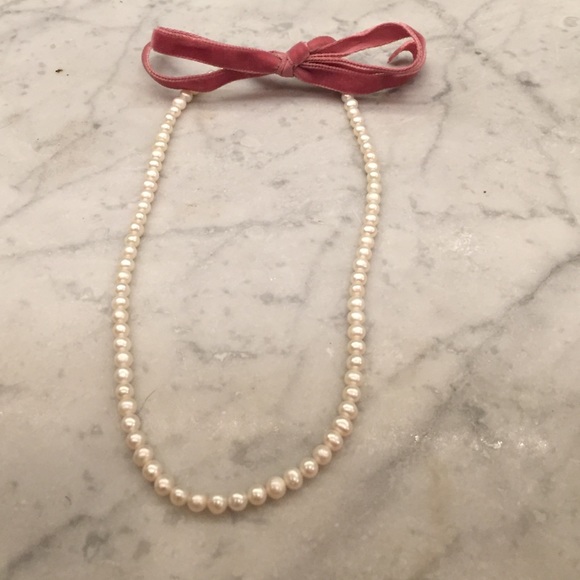 Pink velvet tie and pearl necklace