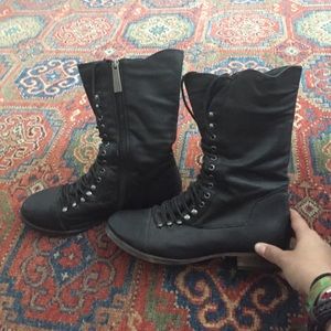 Laced up black combat boots