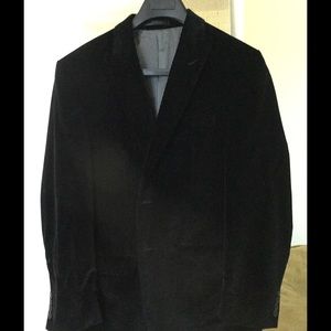 A black Calvin Klein black velvet blazer.