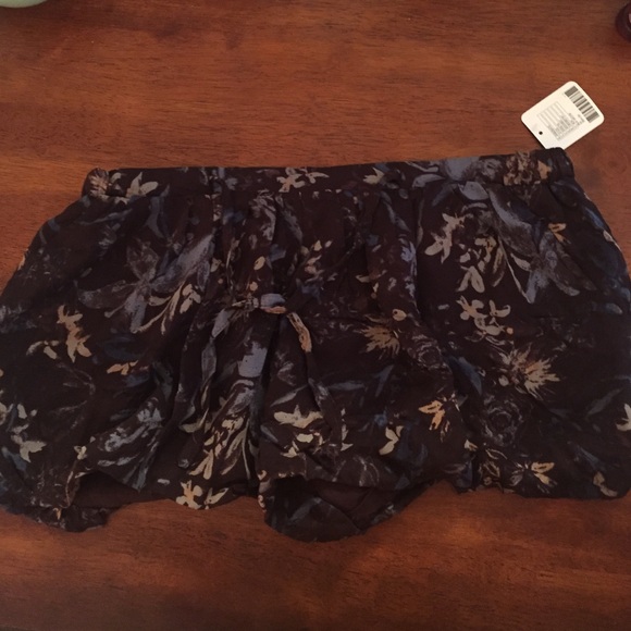 Brown fabric shorts with floral designs