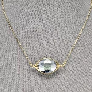 Oval Shaped Clear Pendant Wrapped In Gold