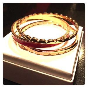 Set of gold and red Kate Spade bangles
