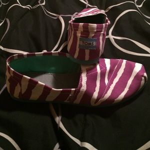 Purple and white zebra print TOMS with a blue bott
