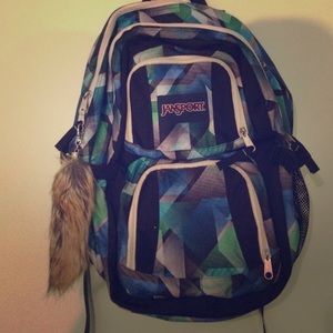 Green, blue and white Jansport book bag