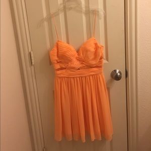 Fun bright tangerine dress with side cutouts!